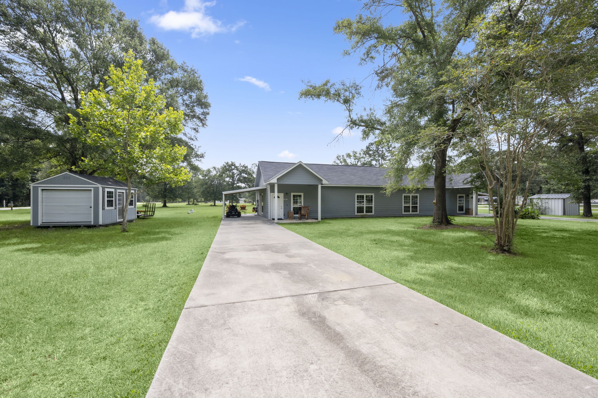 10871 Coaster Lane Conroe, TX 77306 - Photo 2 of 37 Long concrete driveway, with covered parking.