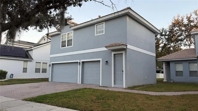 a front view of a house with a yard and garage