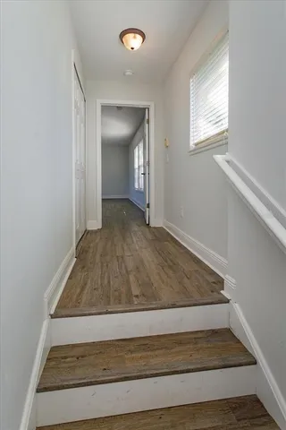 a view of a room with wooden floor and window