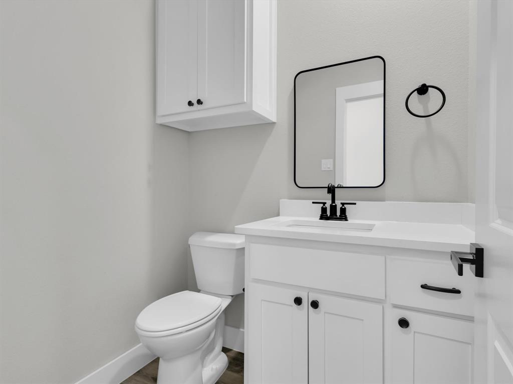 4905 Sweetbay Road Sherman, TX 75092 - Photo 12 of 26 a bathroom with a toilet sink and mirror