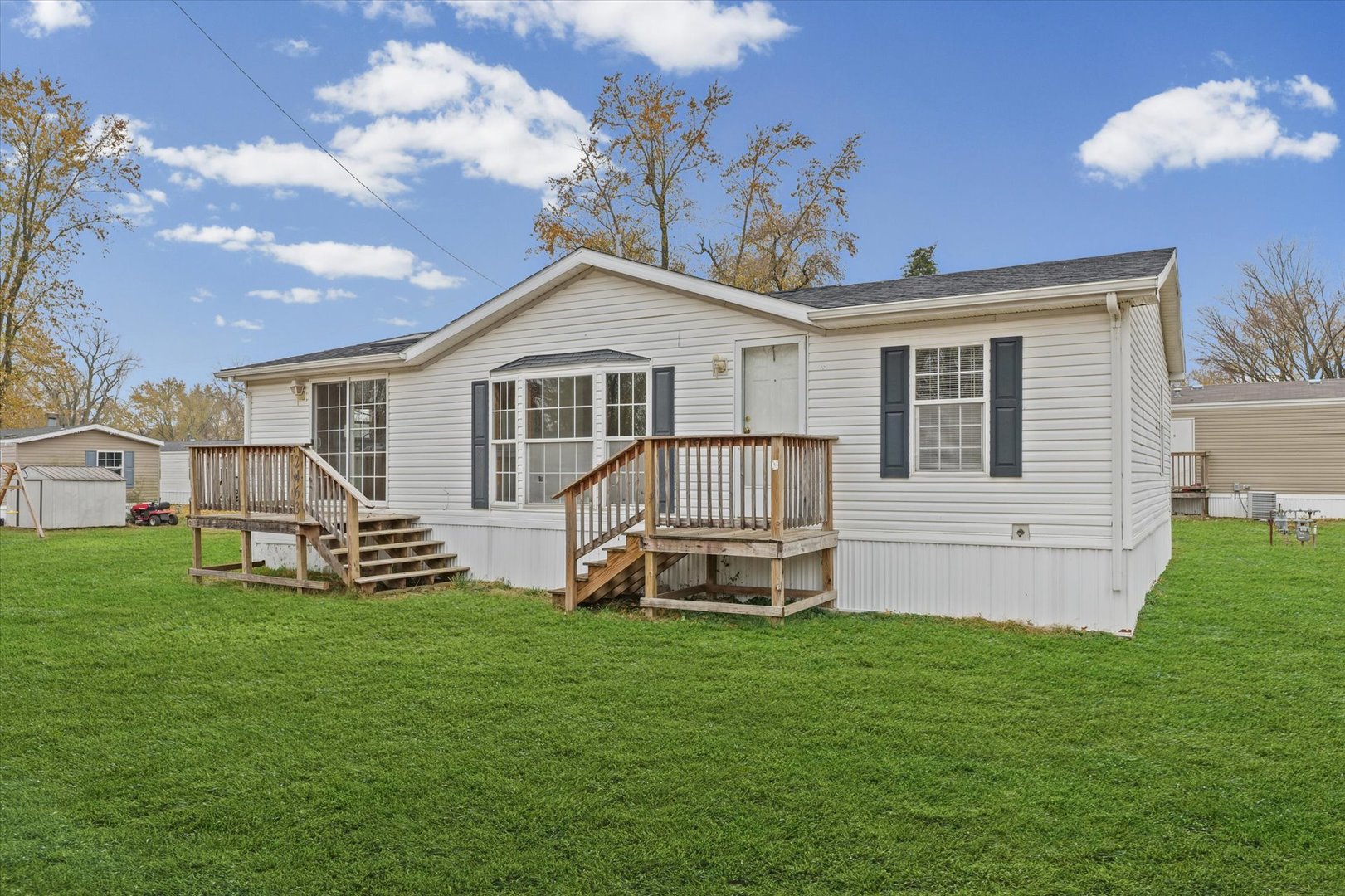 a front view of a house with a garden and yard