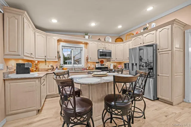 a kitchen with a table chairs refrigerator and cabinets
