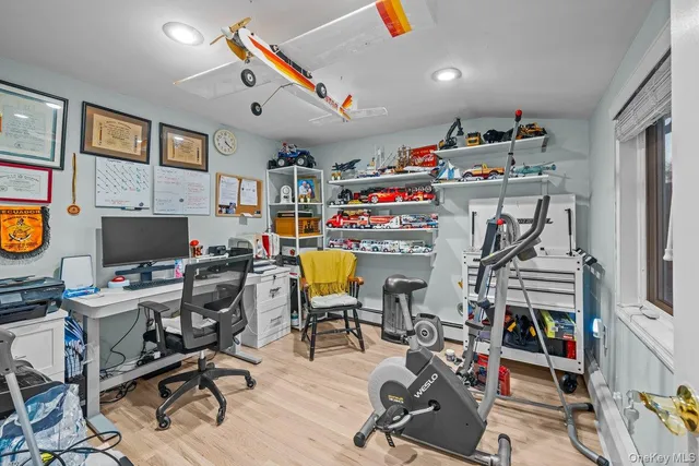 a view of a workspace with furniture and a window