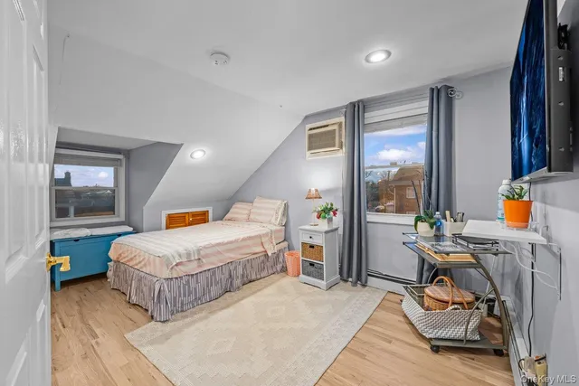 a bedroom with 2 bed and a window