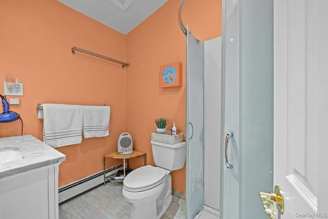 a white toilet sitting next to a bathroom sink