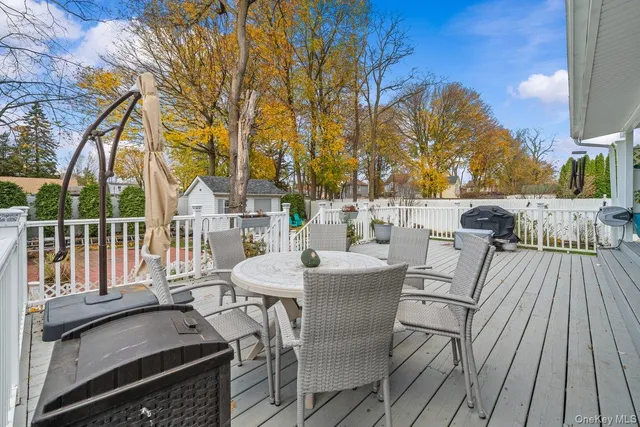 a view of a patio with couches table and chairs and wooden floor