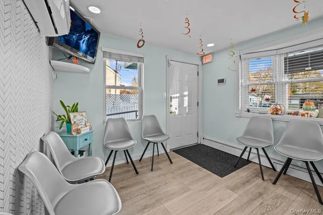 a workspace with furniture window and wooden floor