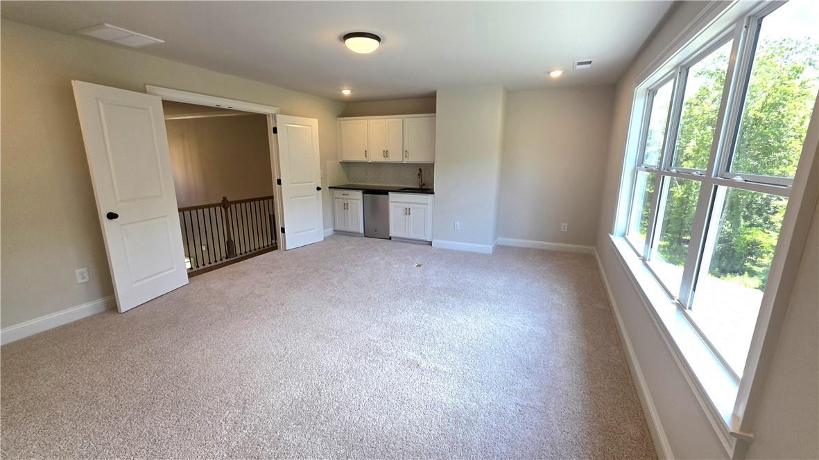 243 Holly Br Road Piedmont, SC 29673 - Photo 18 of 21 A spacious recreation room offers a convenient wet bar and abundant natural light.