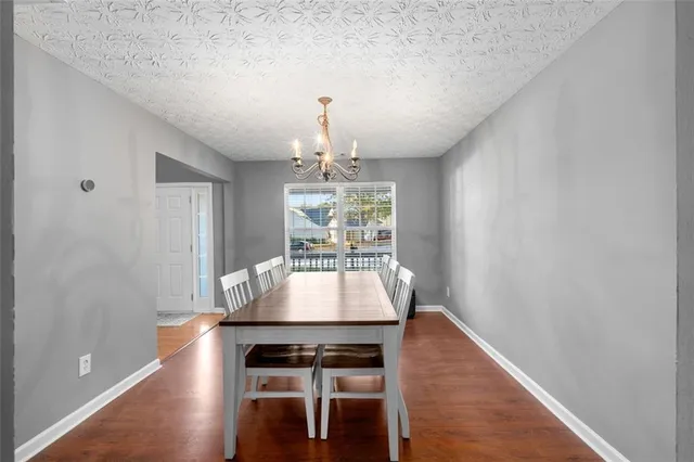a room with wooden floor and chandelier