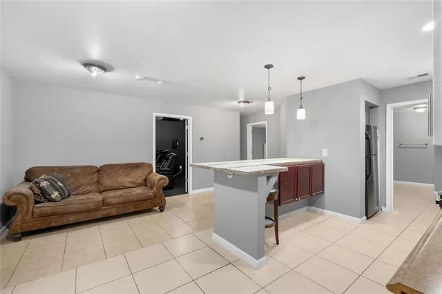a living room with furniture and a dining table with kitchen view