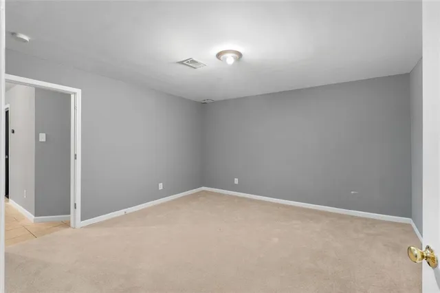 a view of an empty room with a fan