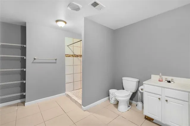 a bathroom with a sink a vanity and granite shower