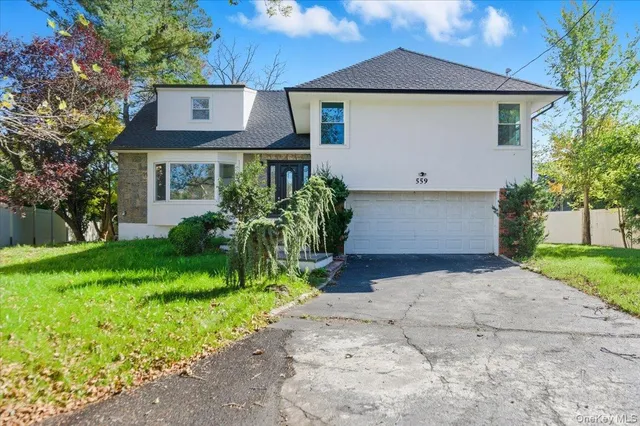 a front view of house with yard and trees