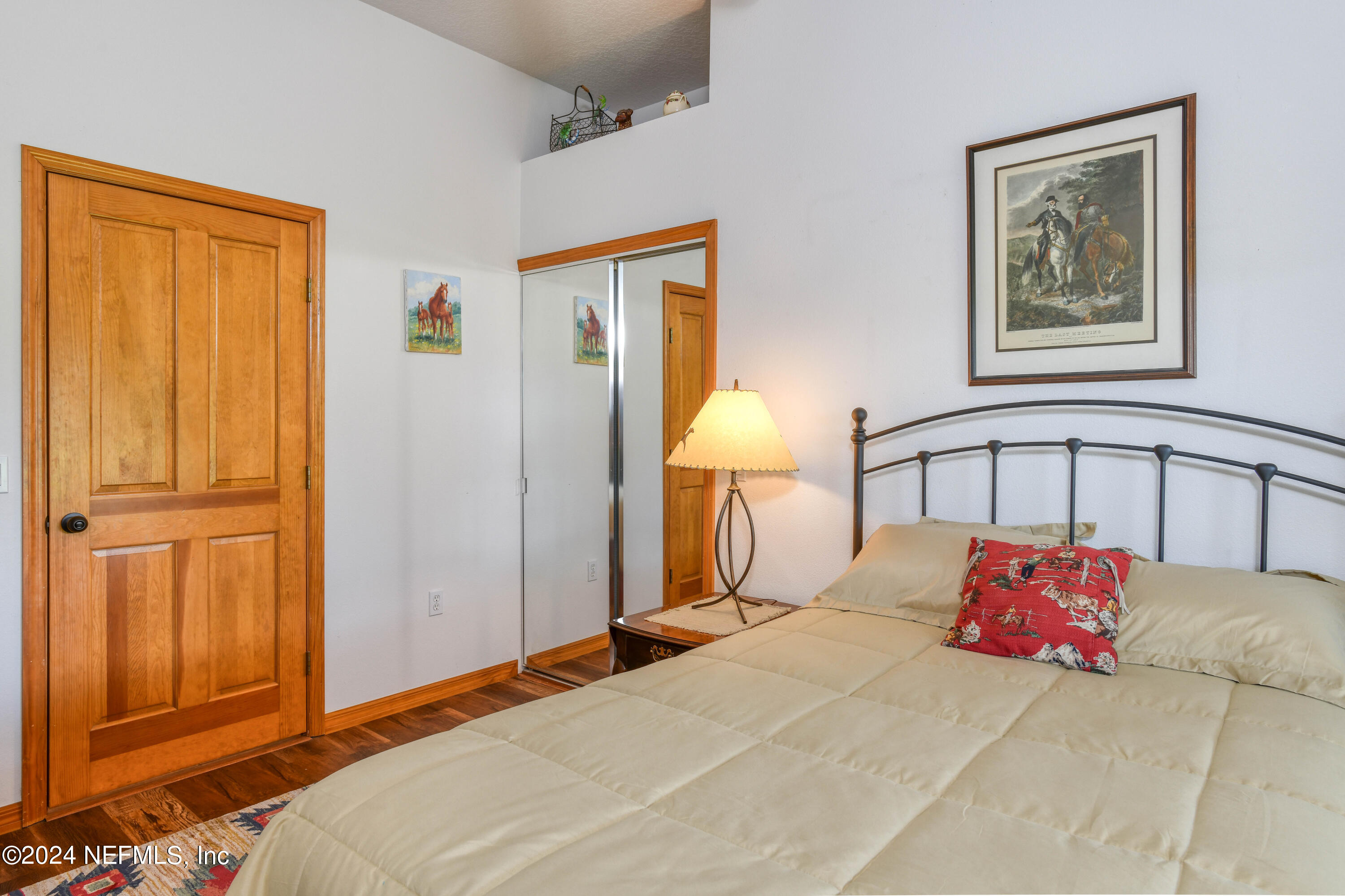 2490 Cade Fernery Road Seville, FL 32190 - Photo 32 of 69 a bedroom with a large bed and a lamp on dresser
