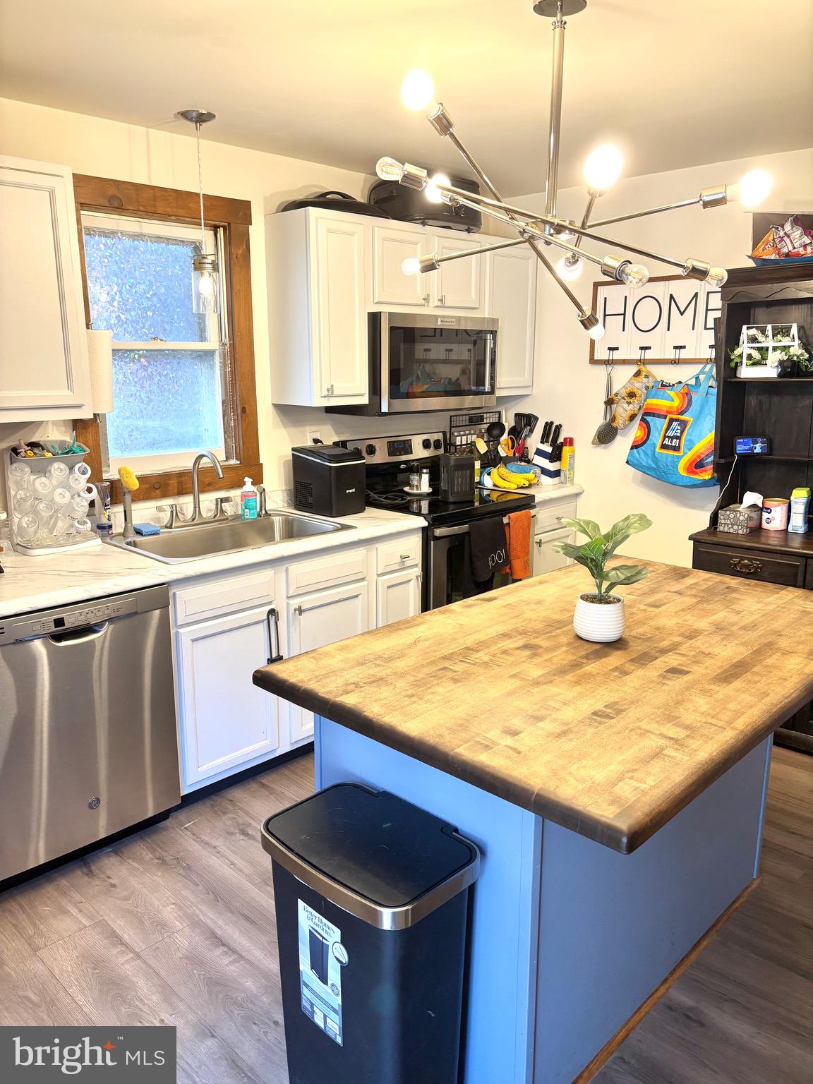 418 Bridge Street Lewistown, PA 17044 - Photo 7 of 23 a kitchen with stainless steel appliances kitchen island granite countertop a sink a counter space and cabinets