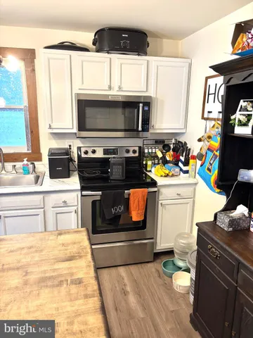 a kitchen with stainless steel appliances a stove microwave and cabinets