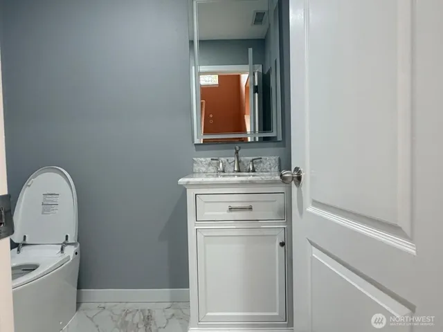 a bathroom with a sink vanity and a mirror
