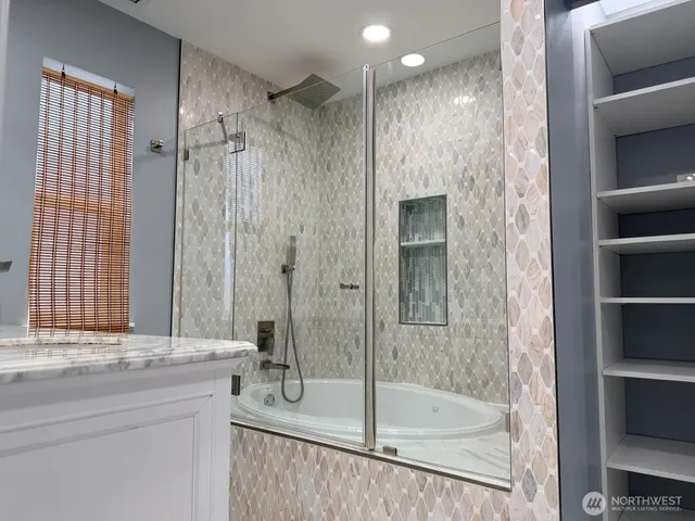 a bathroom with a shower and a sink