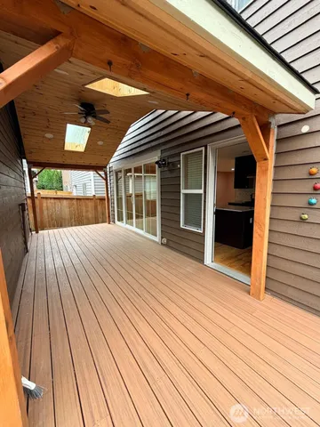 a view of backyard with wooden deck and large wooden floor