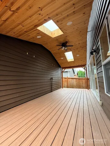 a view of backyard with a deck and wooden floor