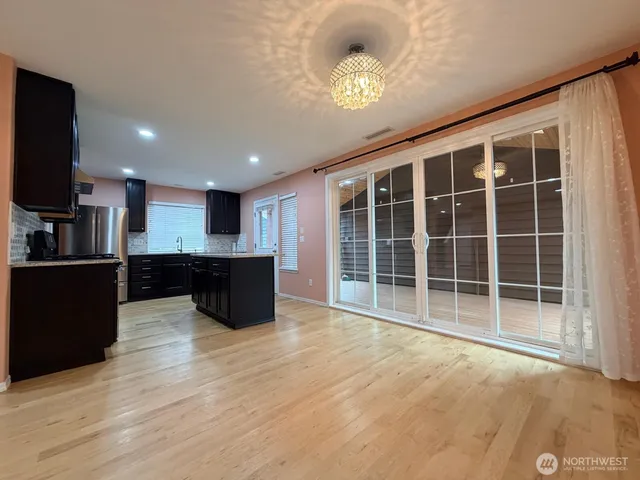 a large room with kitchen view and a window