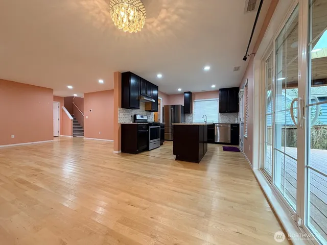 a view of kitchen with refrigerator and a stove