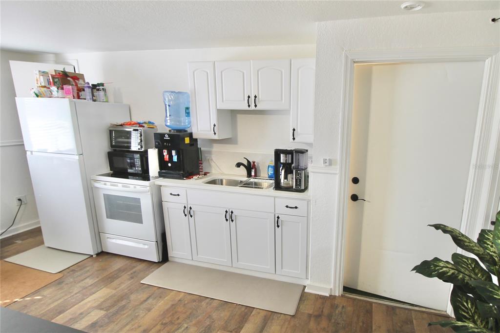 608 Dundee Road Dundee, FL 33838 - Photo 60 of 77 a kitchen with white cabinets and white appliances