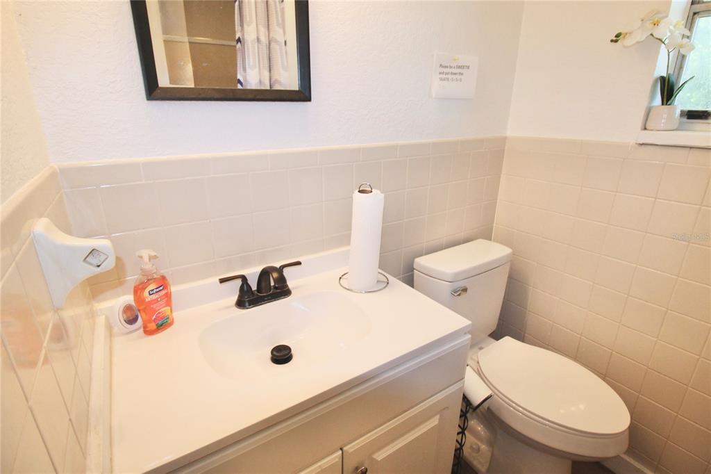 608 Dundee Road Dundee, FL 33838 - Photo 64 of 77 a white toilet sitting next to a bathroom sink