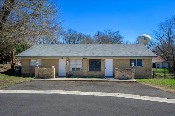 a front view of house with yard and trees