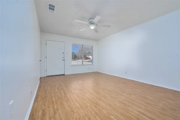 a view of an empty room and a window