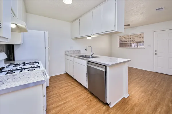 a kitchen with a sink stove and cabinets