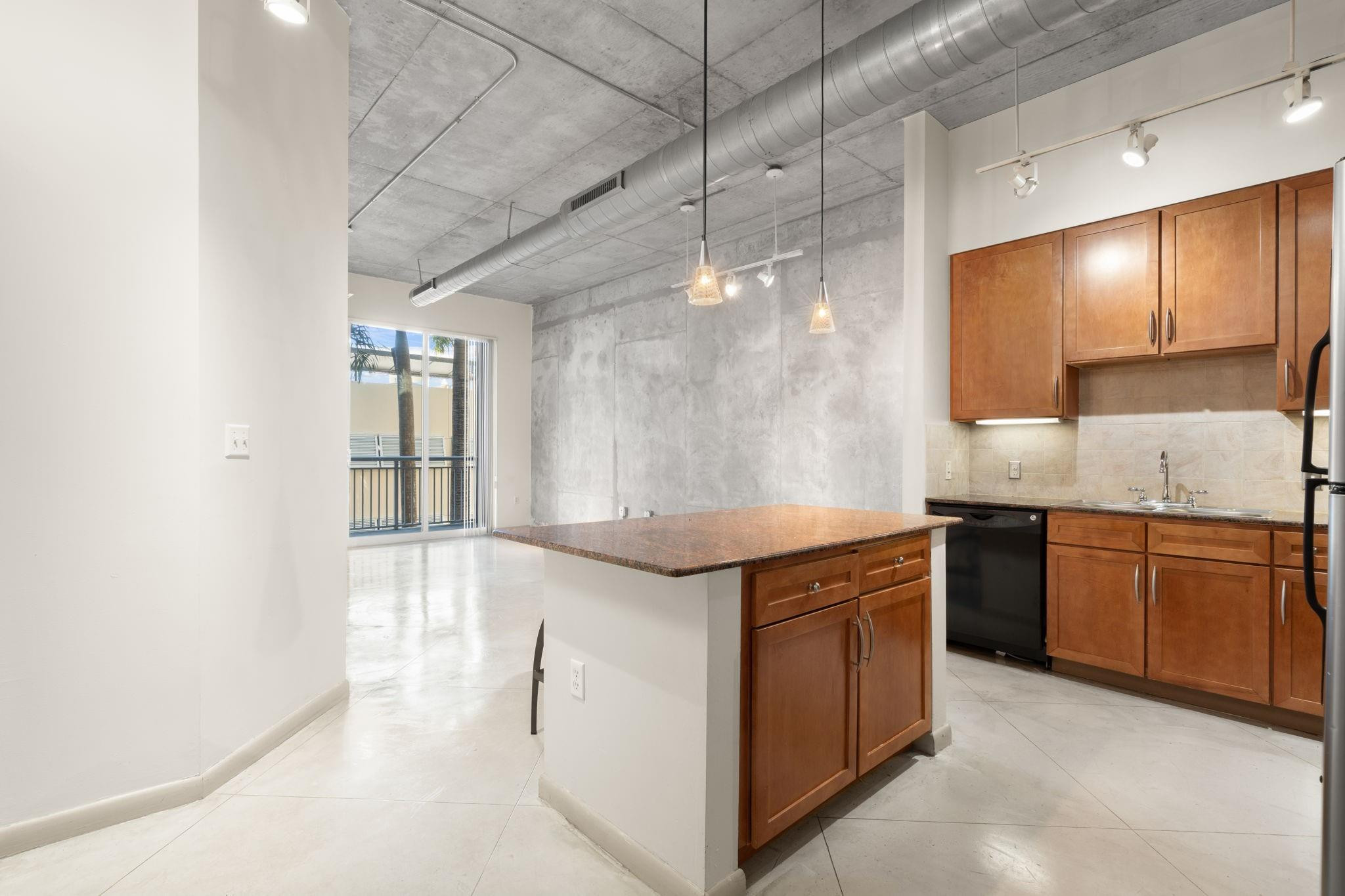 2001 Biscayne Boulevard, Unit 2303 Miami, FL 33137 - Photo 6 of 36 a kitchen with stainless steel appliances granite countertop a sink and a stove