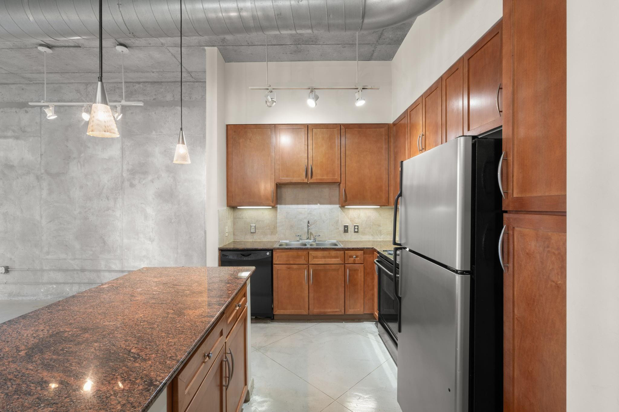 2001 Biscayne Boulevard, Unit 2303 Miami, FL 33137 - Photo 8 of 36 a kitchen with stainless steel appliances granite countertop a refrigerator and a sink