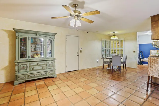 a view of kitchen with furniture and chandelier fan