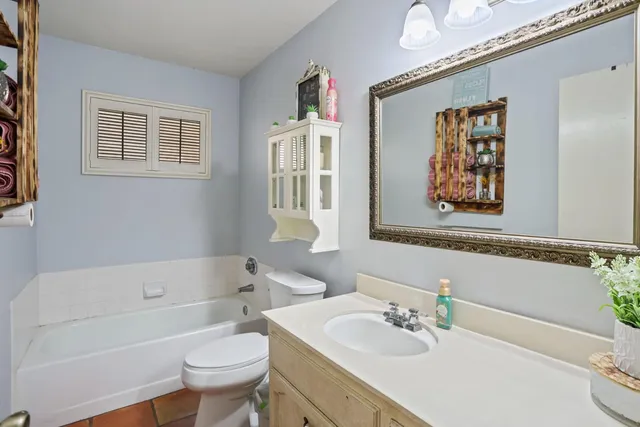 a bathroom with a sink a toilet and a bathtub