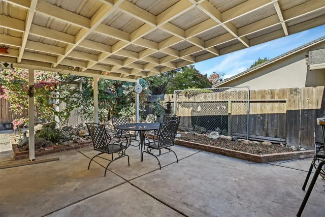 a view of a chairs and table in backyard