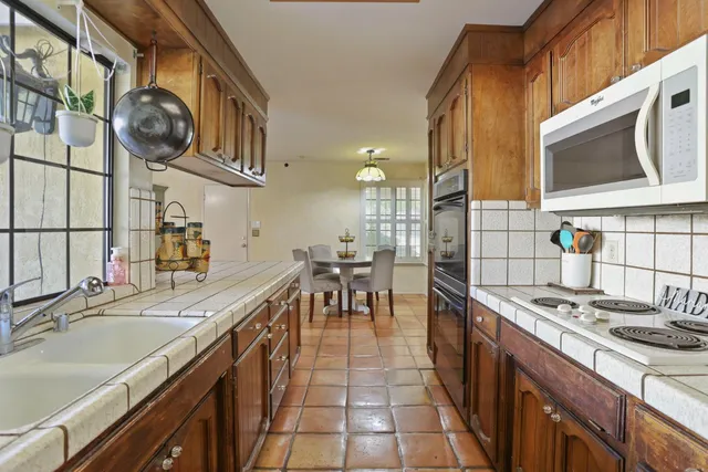 a kitchen with stainless steel appliances granite countertop a sink and stove