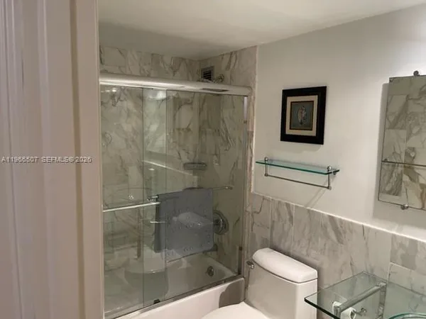 a bathroom with a shower and toilet