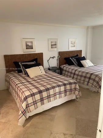 a bedroom with two beds and painting on the wall