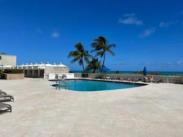 a view of a swimming pool and a yard