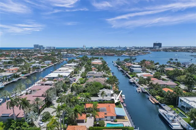an aerial view of a houses with a lake view