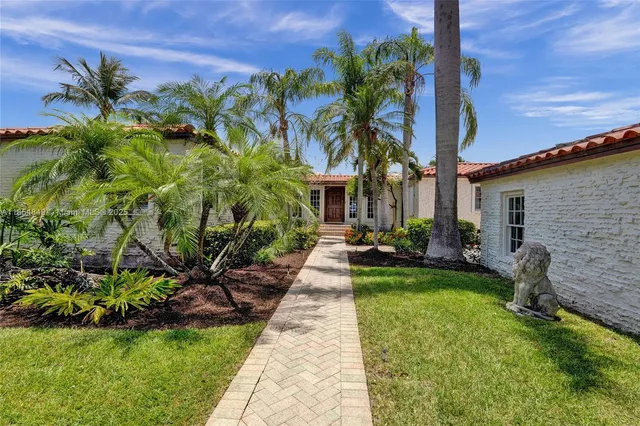 a living room with furniture a fireplace and a floor to ceiling window
