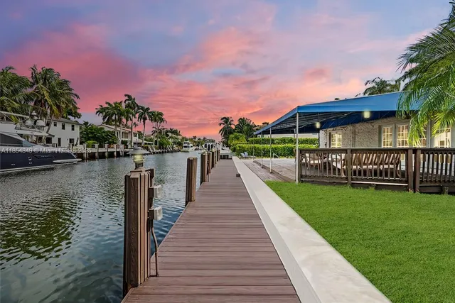 front view of a house with a yard and potted plants
