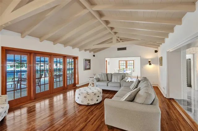 a living room with fireplace furniture and a wooden floor