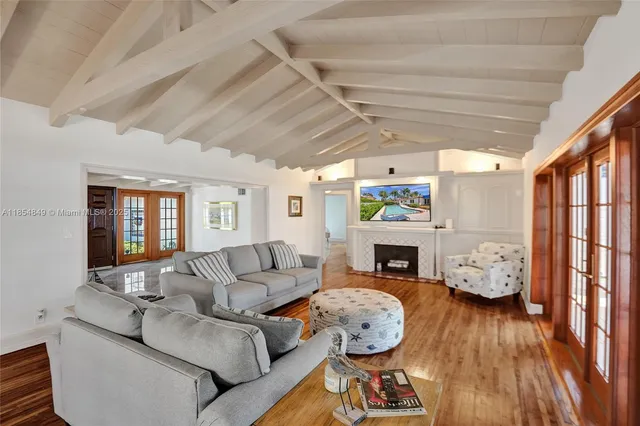 a kitchen with a refrigerator a stove a microwave and white cabinets