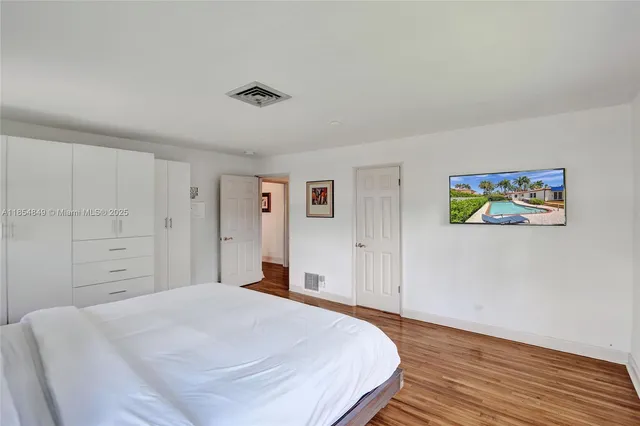 a spacious bedroom with a bed and a window