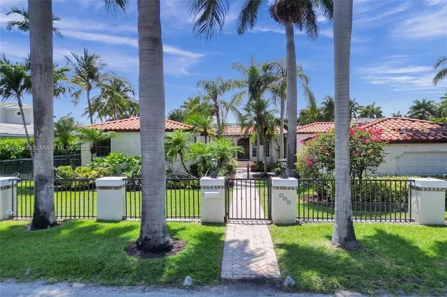 an aerial view of a houses with a lake view