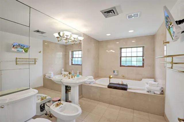 front view of house with a yard and potted plants