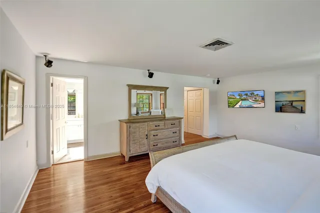 a view of a lake with boats and palm trees