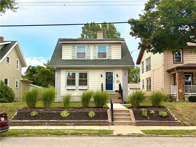 a front view of a house with garage and windows